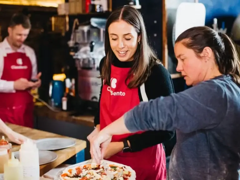 two people at a pizza cooking class