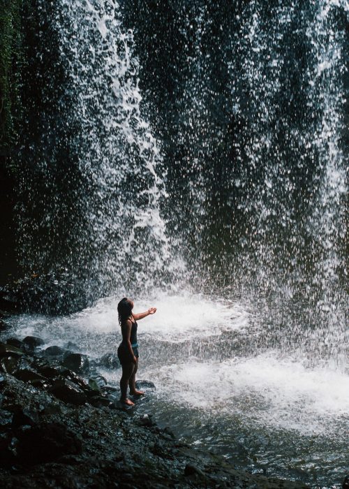 Woman at the bottom of a Byron Bay waterfall