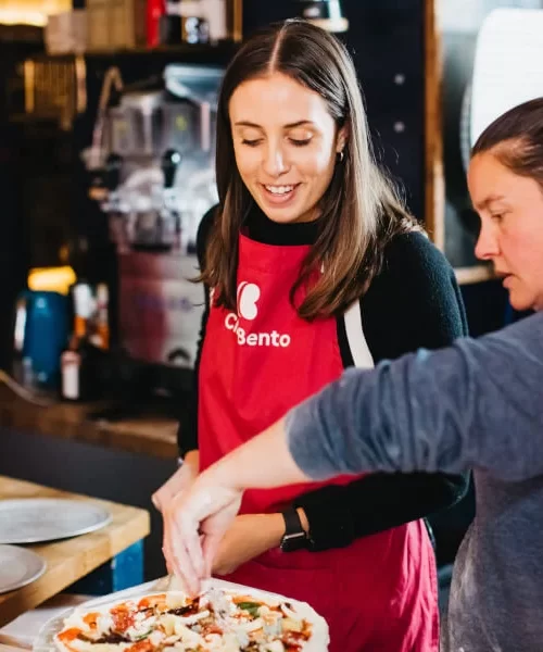 two people at a pizza cooking class