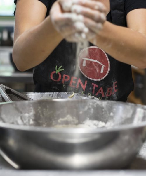 hands covered in flour making dough